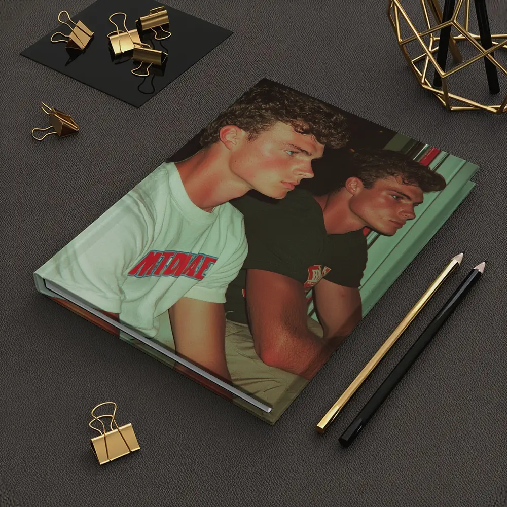 Two Young Men Sitting Together Indoors – Notebooks