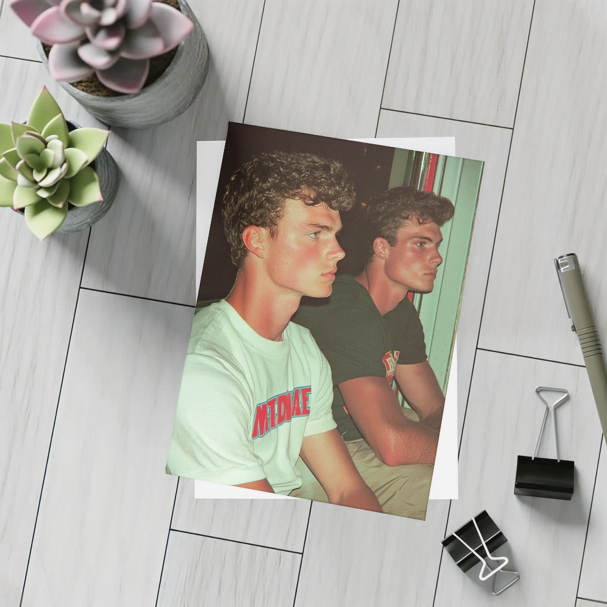 Two Young Men Sitting Together Indoors – Postcards