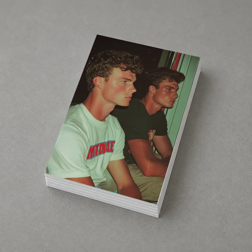 Two Young Men Sitting Together Indoors – Postcards