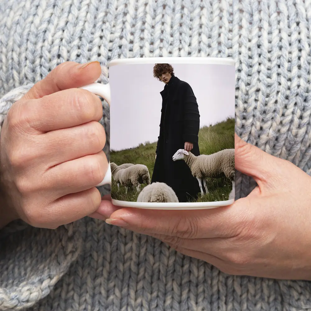 Young Man Black Coat Sheep Green Field – Mugs