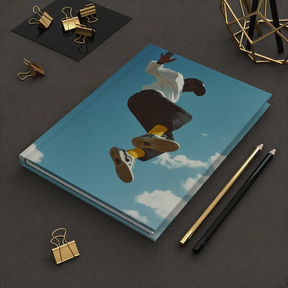 Man Jumping High Against Blue Sky – Notebooks