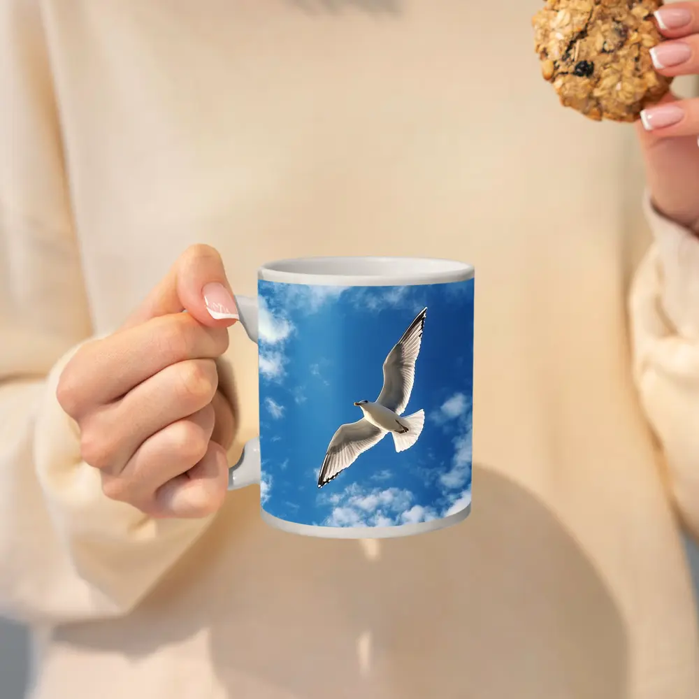 Seagull Flying Against Blue Cloudy Sky – Mugs