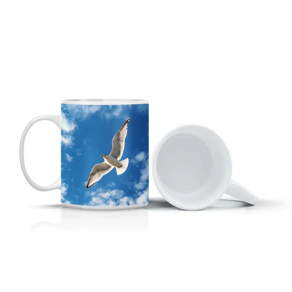Seagull Flying Against Blue Cloudy Sky – Mugs