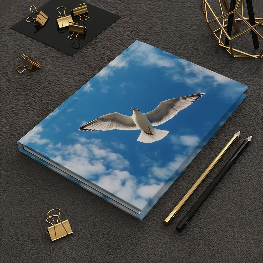 Seagull Flying Against Blue Cloudy Sky – Notebooks