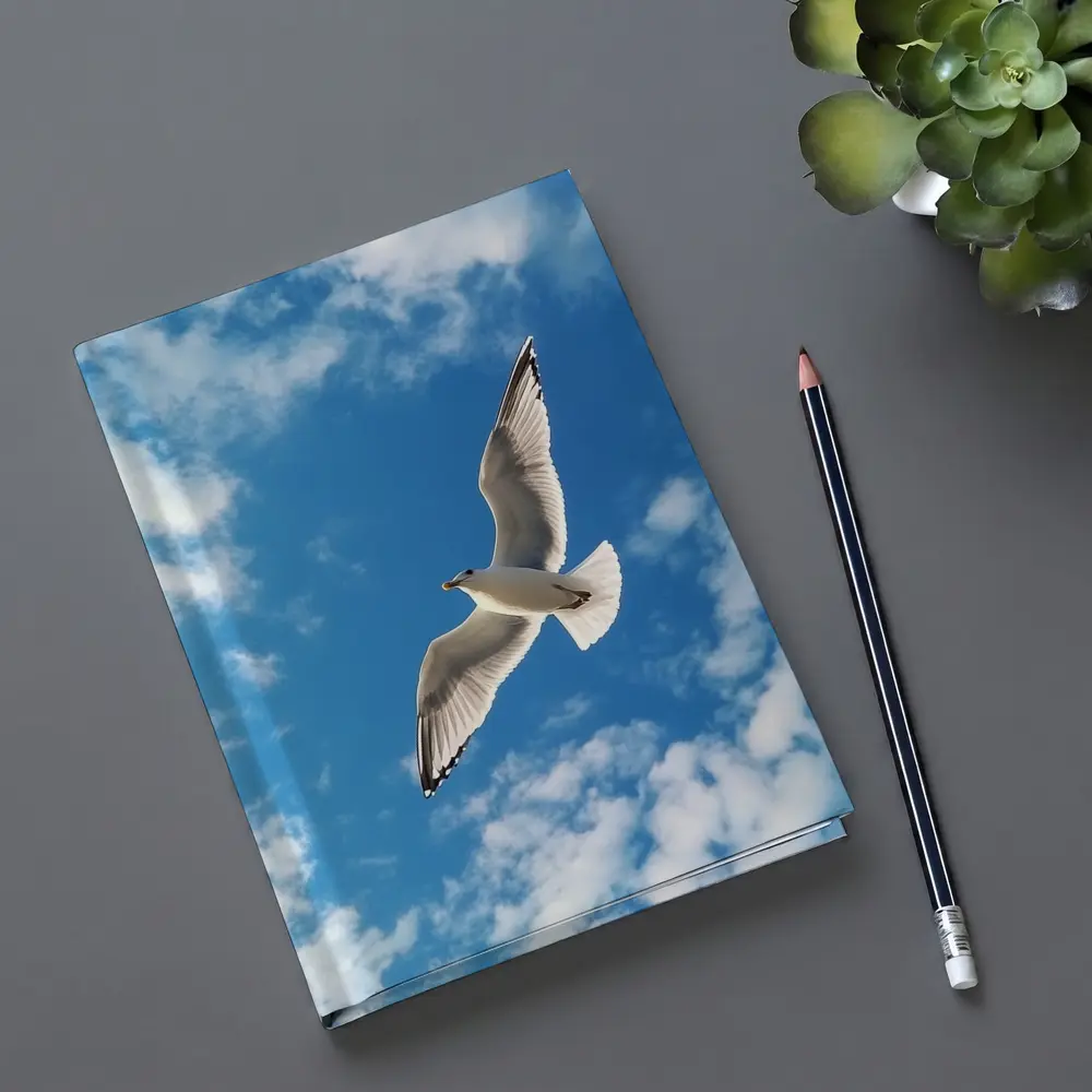 Seagull Flying Against Blue Cloudy Sky – Notebooks