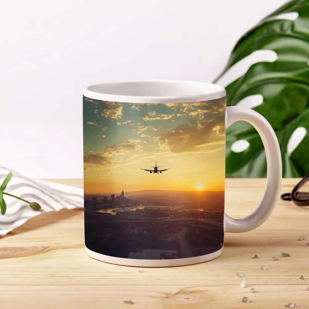 Airplane Silhouette Flying Over City Sunset – Mugs