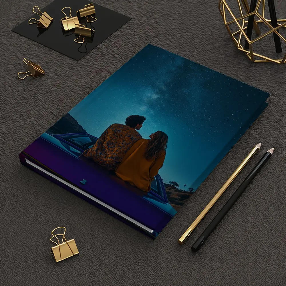 Couple Sitting on Car Under Starry Sky – Notebooks