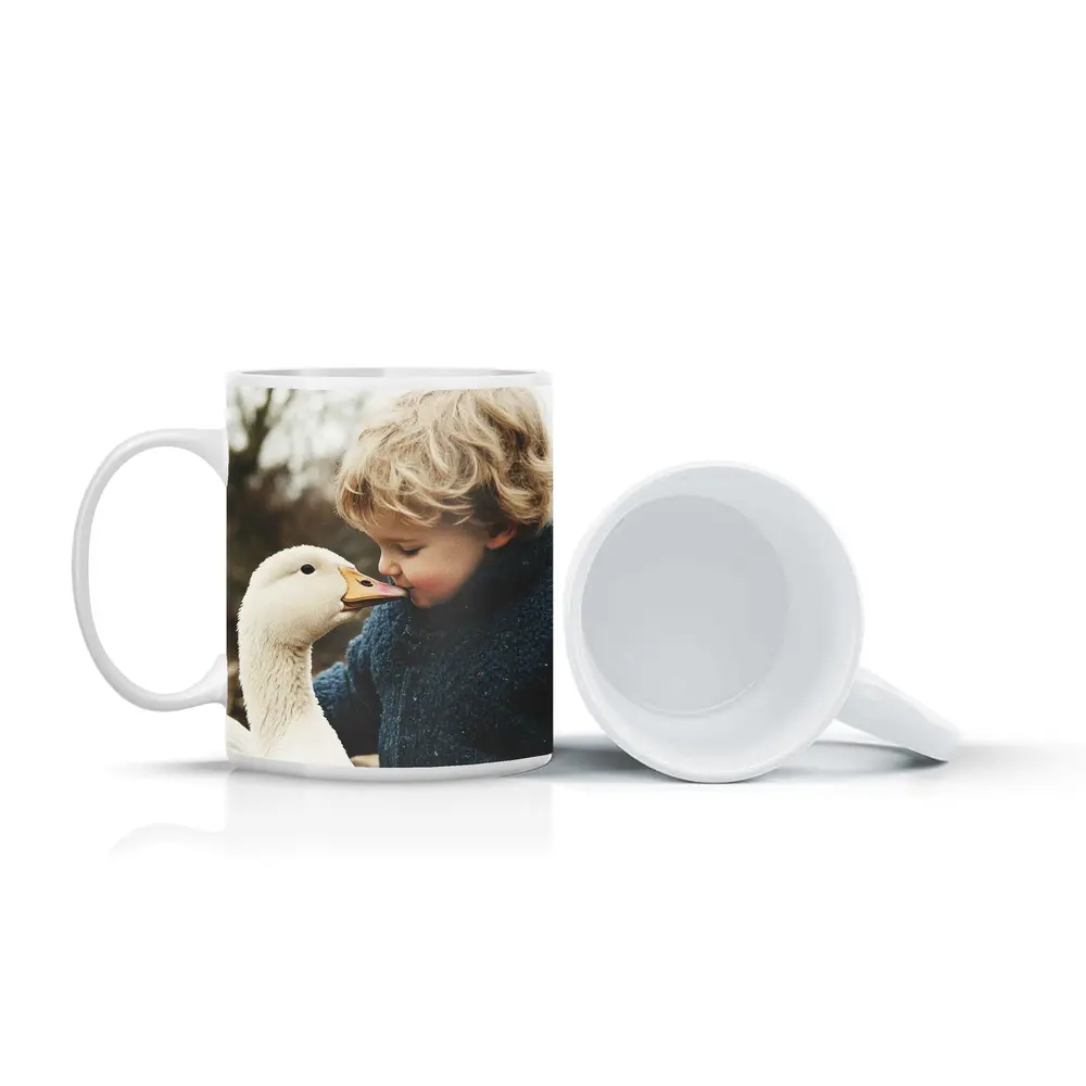 Child Kissing White Goose Outdoors – Mugs