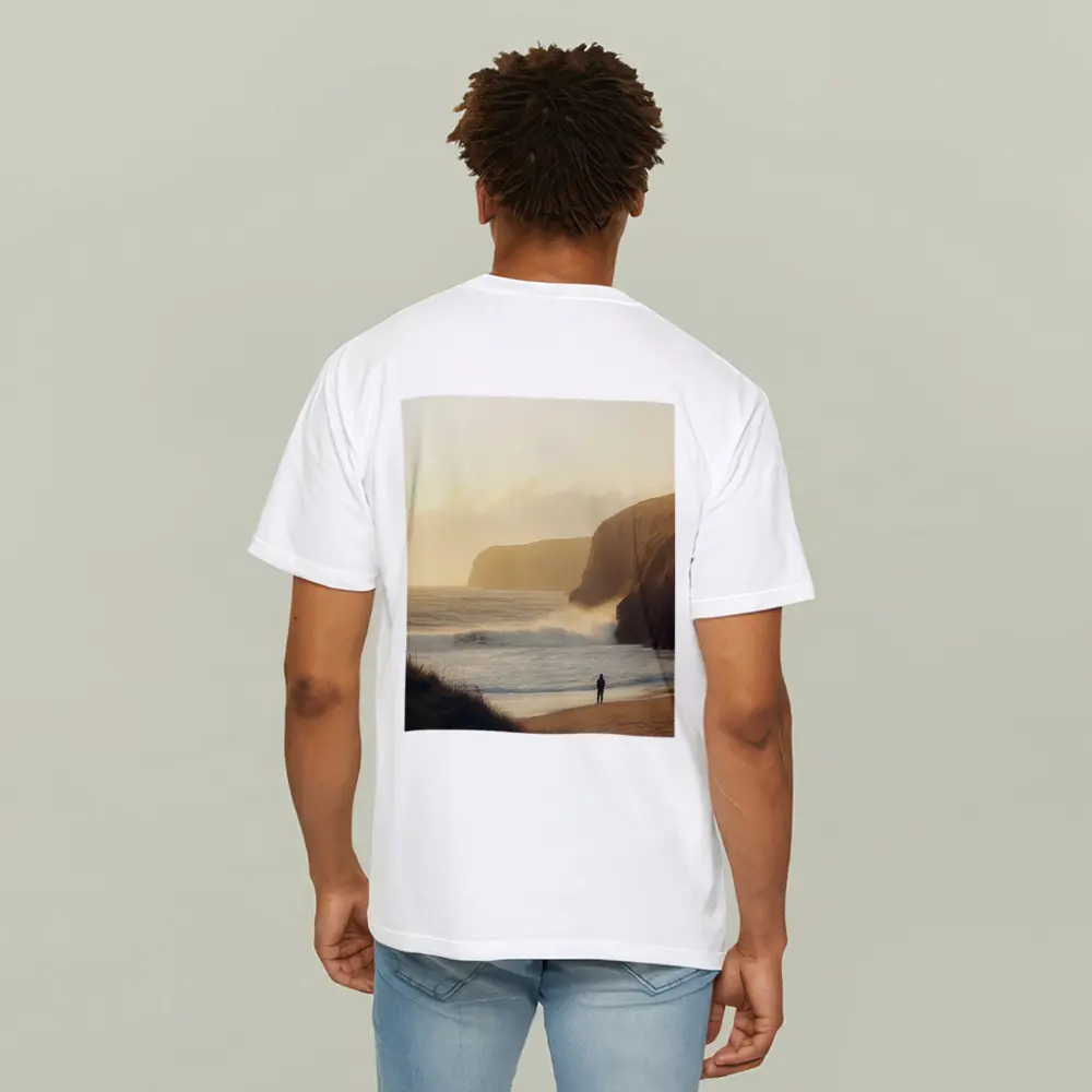 Lone Figure Standing on Golden Coastal Beach – T-Shirts