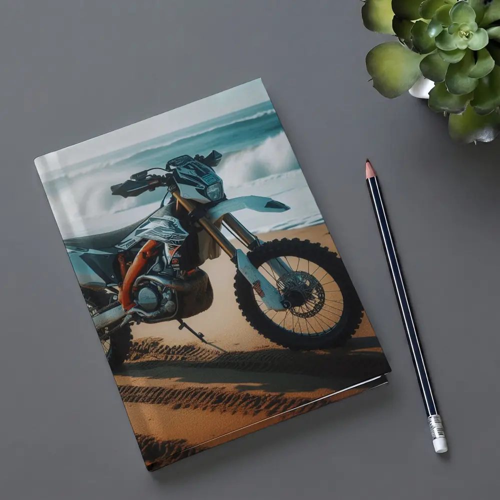 KTM Dirt Bike Parked on Sandy Beach – Notebooks