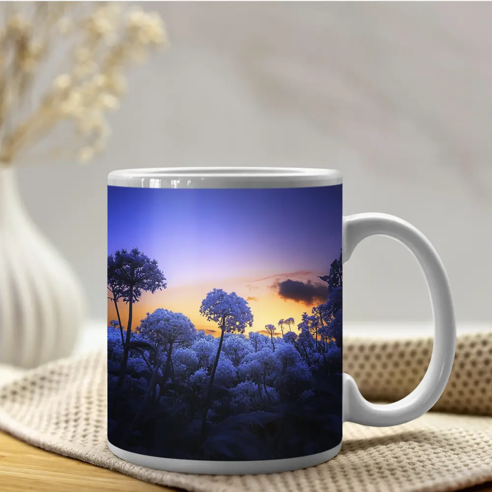 Blue Flowers Glowing Against Sunset Sky – Mugs