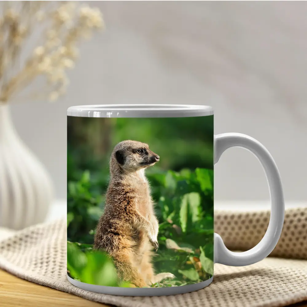 Meerkat Standing Alert In Green Foliage – Mugs