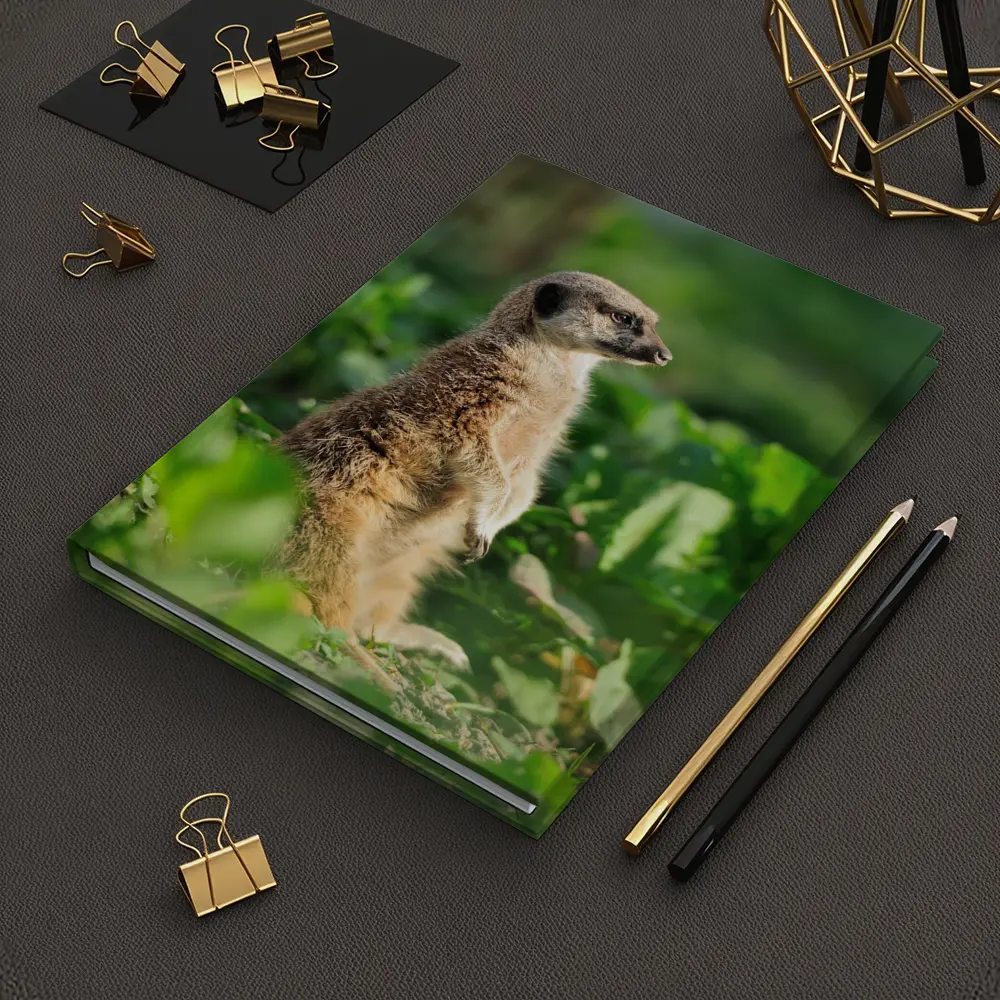Meerkat Standing Alert In Green Foliage – Notebooks