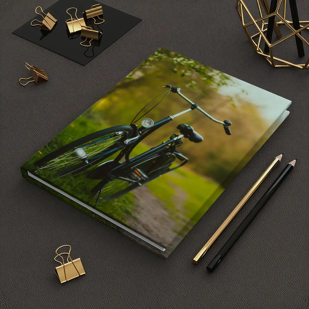 Black City Bicycle Parked On Green Path – Notebooks