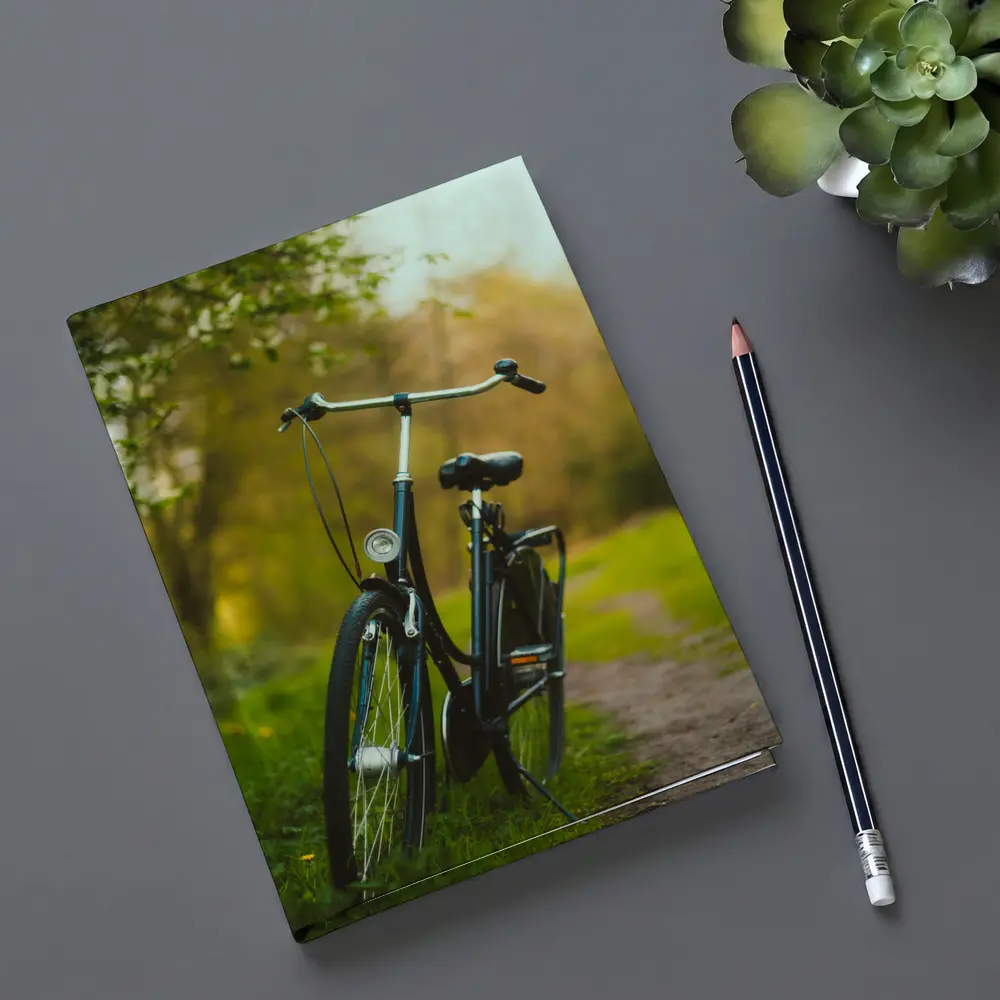 Black City Bicycle Parked On Green Path – Notebooks