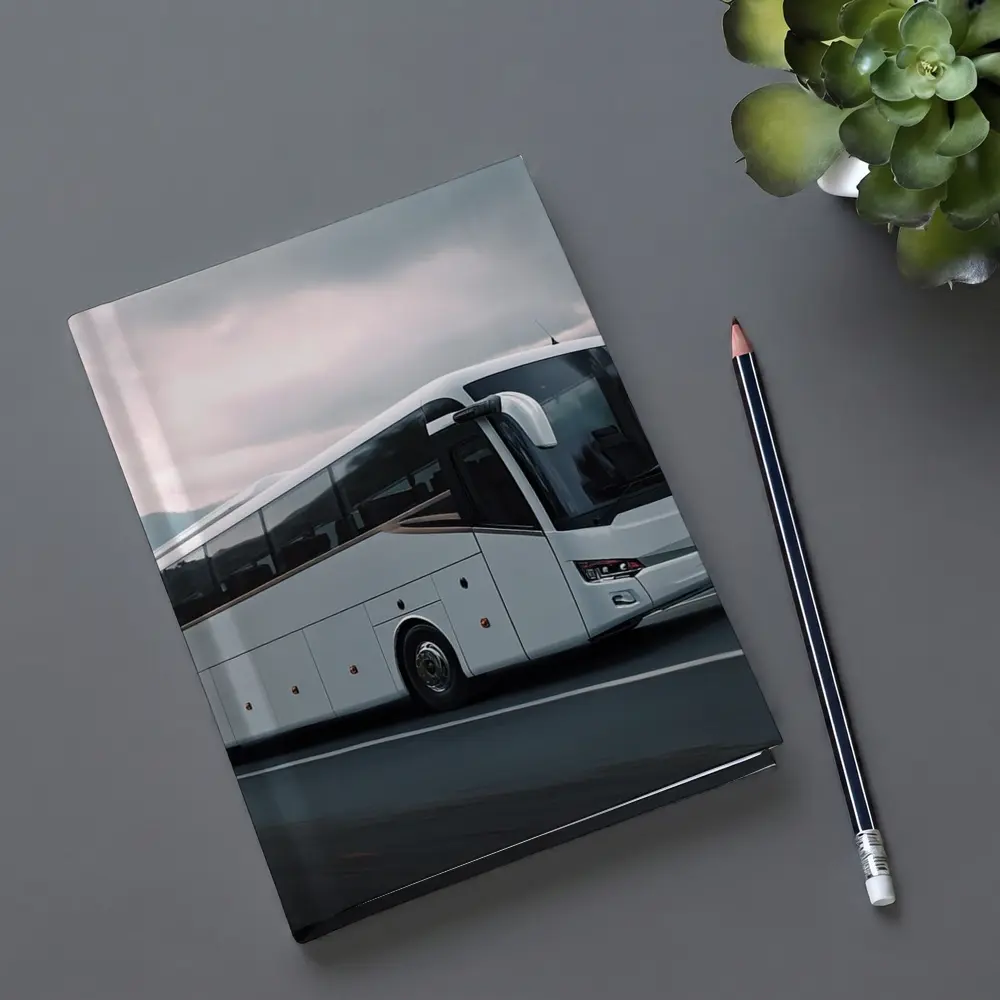 White Coach Bus Driving Through Mountain Road – Notebooks