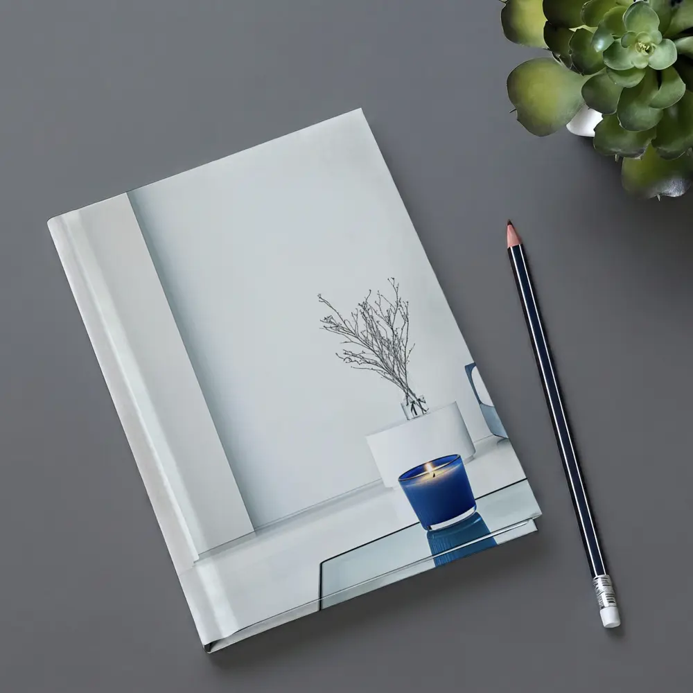 Blue Candle Glowing in Minimalist White Room – Notebooks