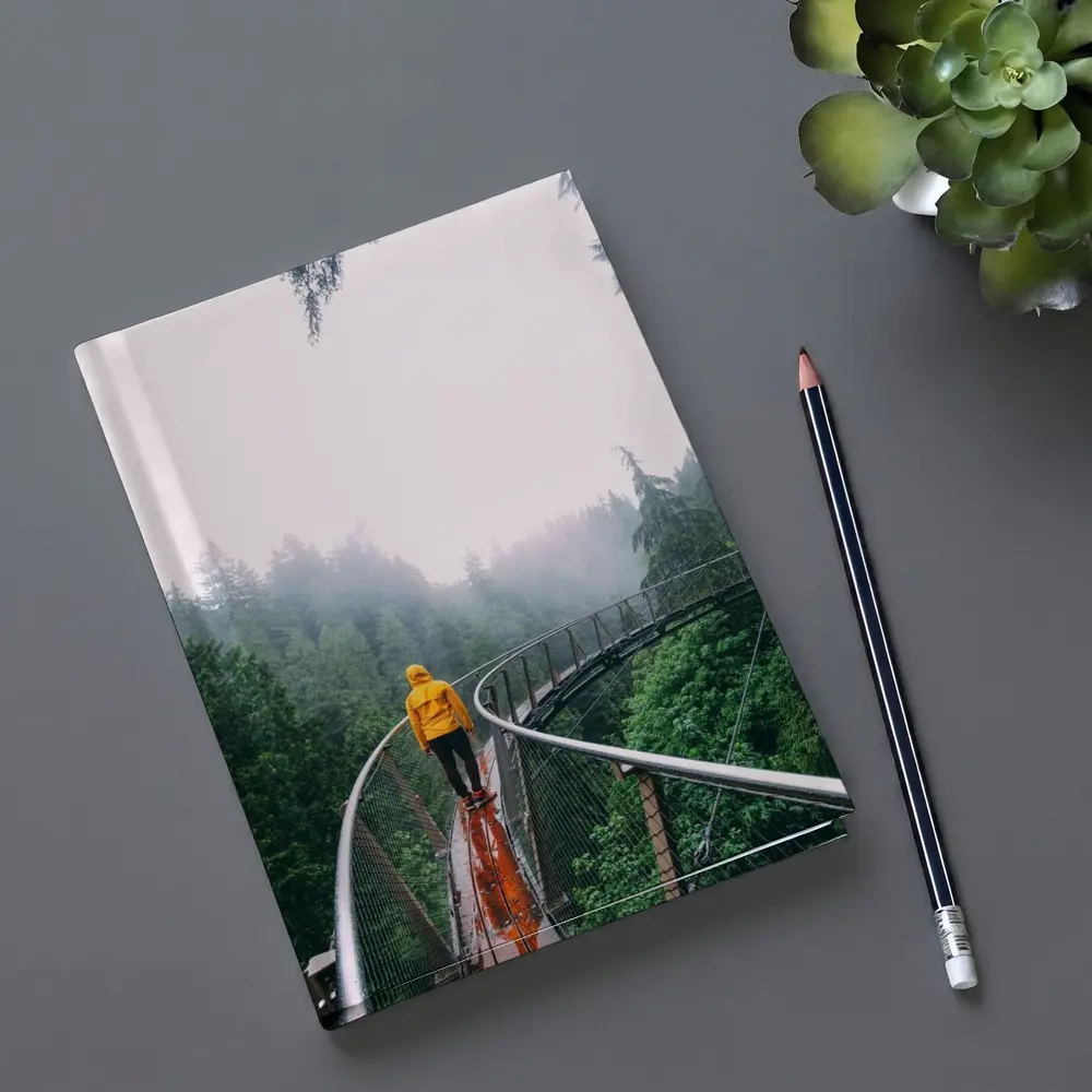 Yellow Jacket Hiker on Misty Forest Bridge – Notebooks