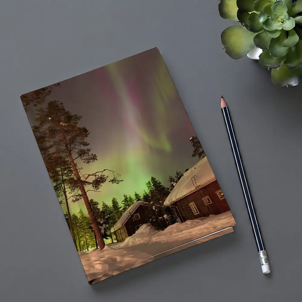 Northern Lights Over Snowy Winter Cabins – Notebooks