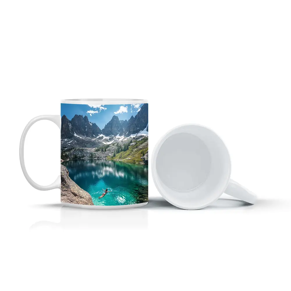 Person Swimming Alpine Lake Jagged Mountain Peaks – Mugs