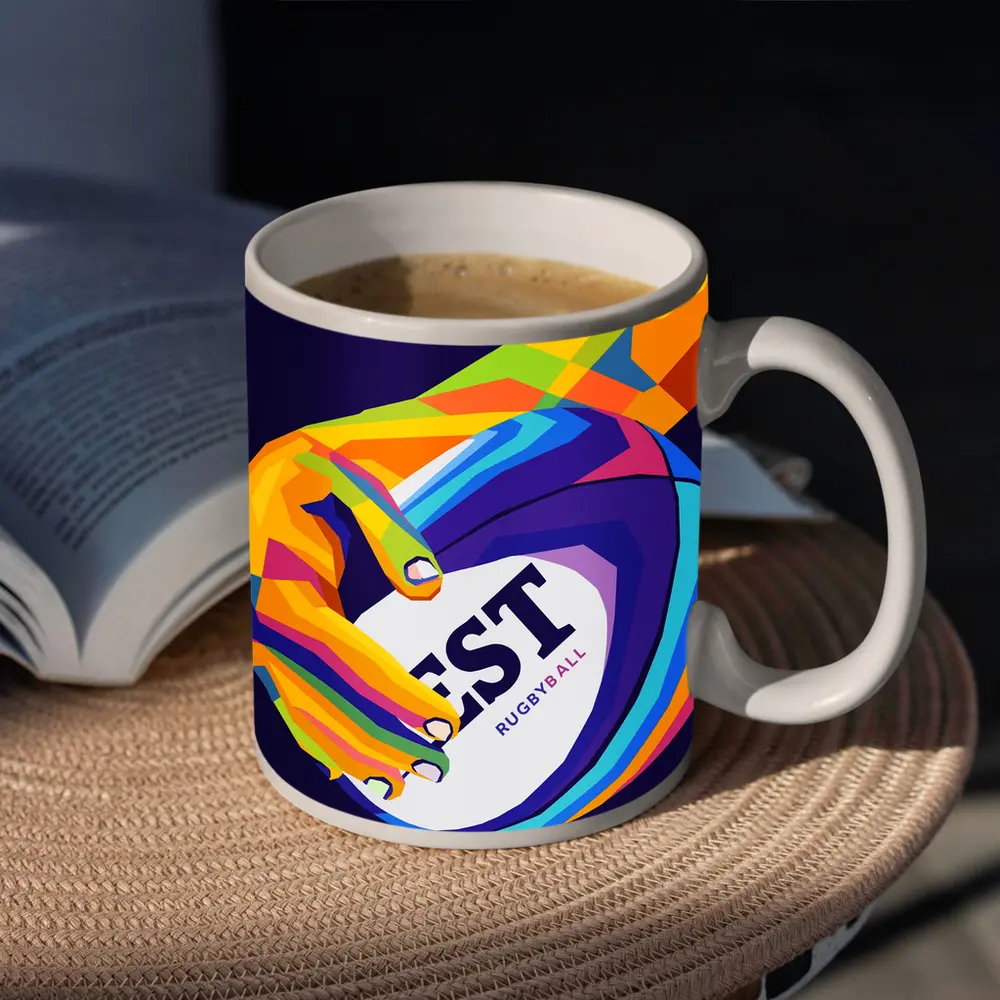 Rainbow Hand Gripping Rugby Ball Dark Background – Mugs