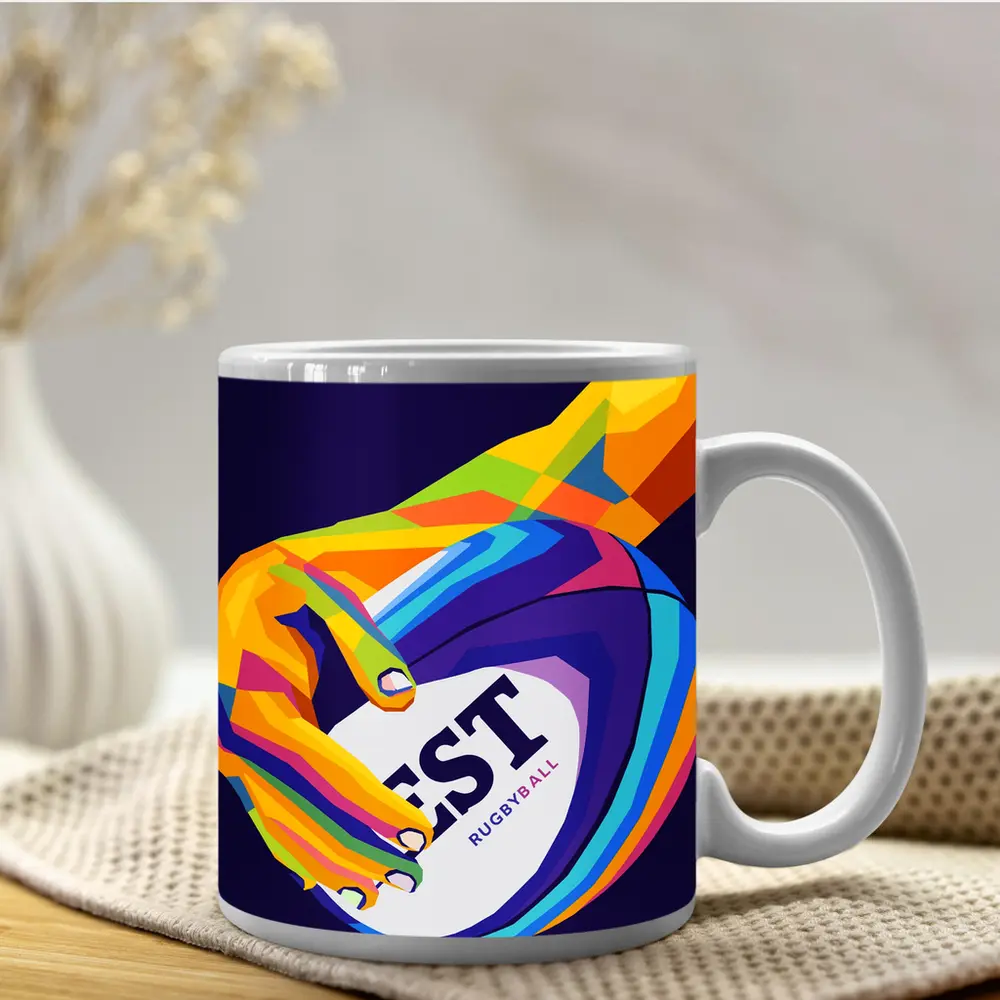 Rainbow Hand Gripping Rugby Ball Dark Background – Mugs