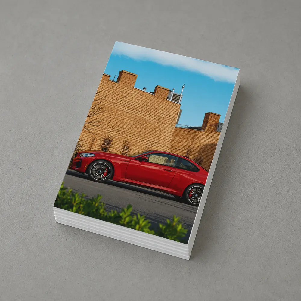 Red BMW M2 Parked Against Brick Wall – Postcards