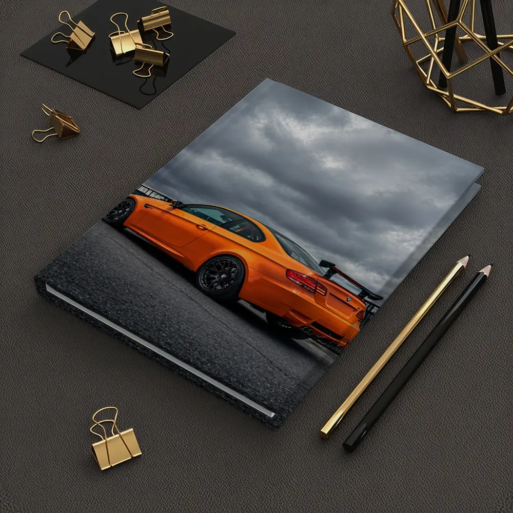 BMW M3 GTS Orange Under Stormy Sky – Notebooks