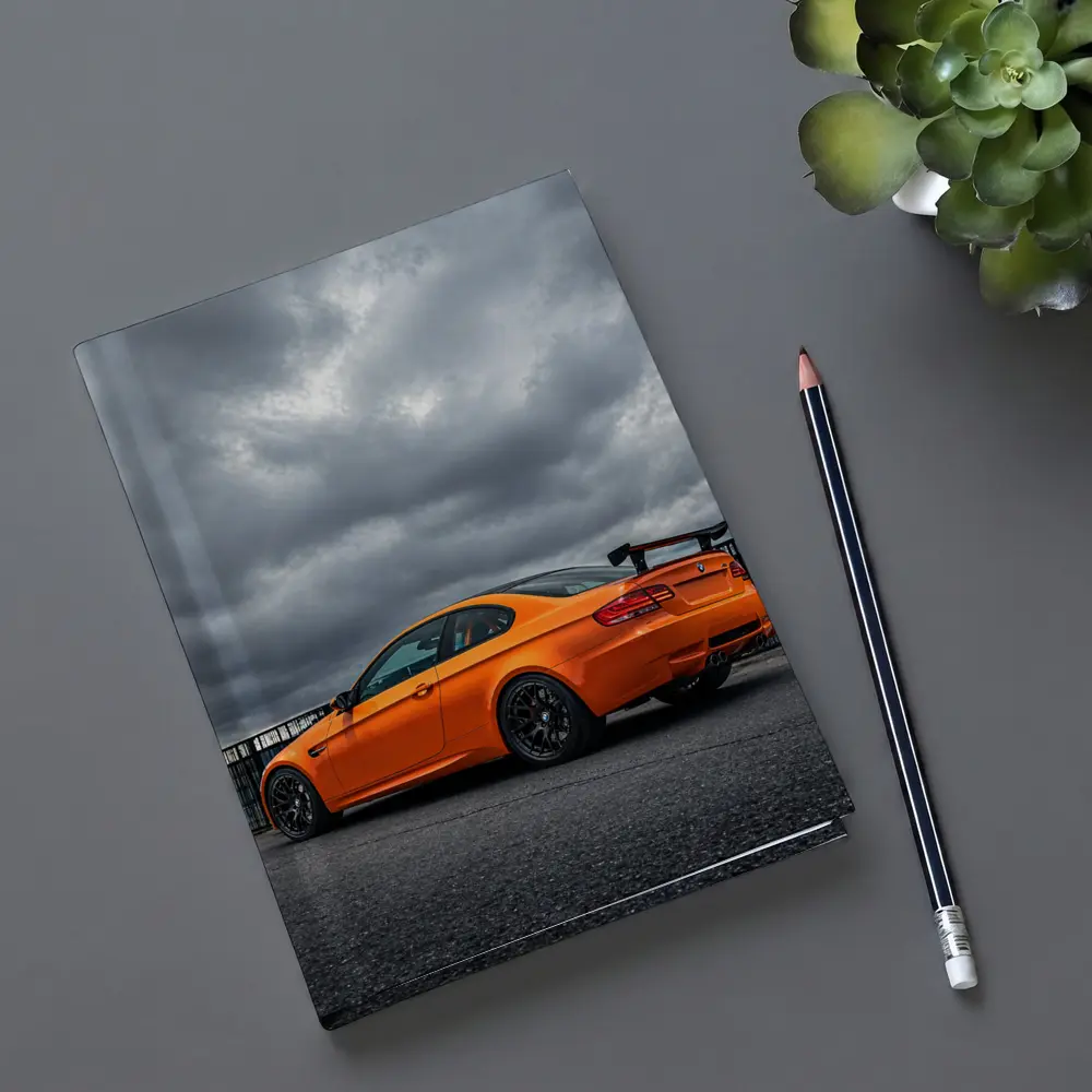 BMW M3 GTS Orange Under Stormy Sky – Notebooks