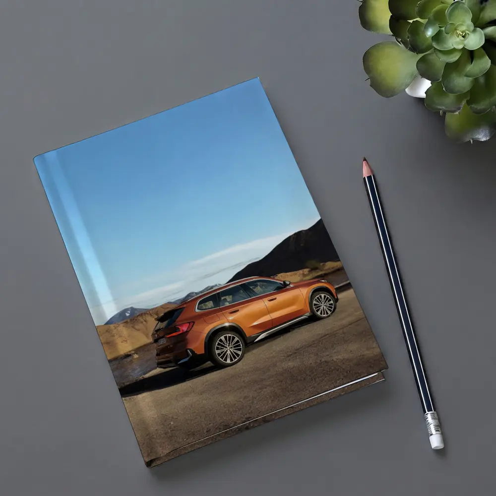 BMW X1 Orange SUV Desert Mountain Backdrop – Notebooks