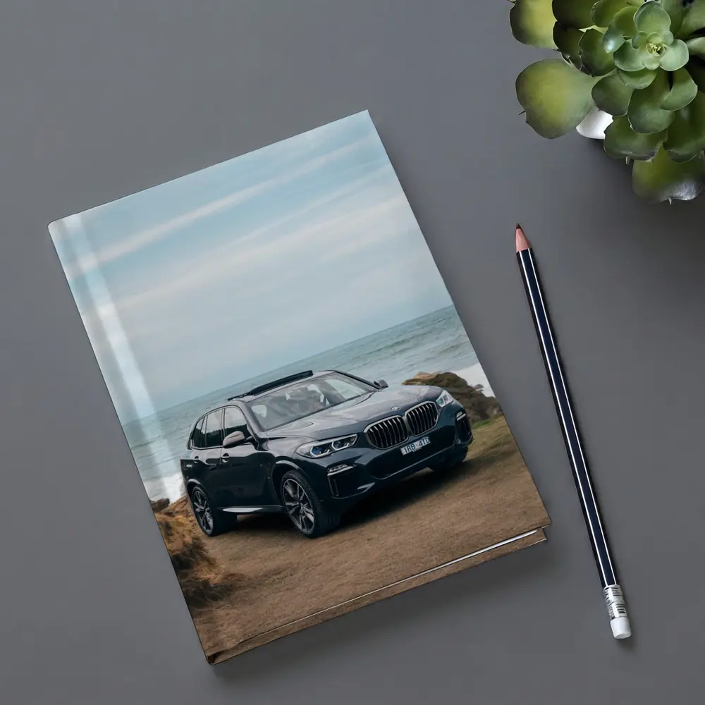 BMW X5 Parked by Coastal Rocky Shore – Notebooks