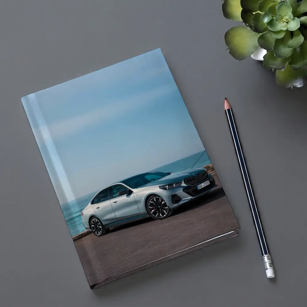 BMW i5 Sedan Parked by the Ocean – Notebooks