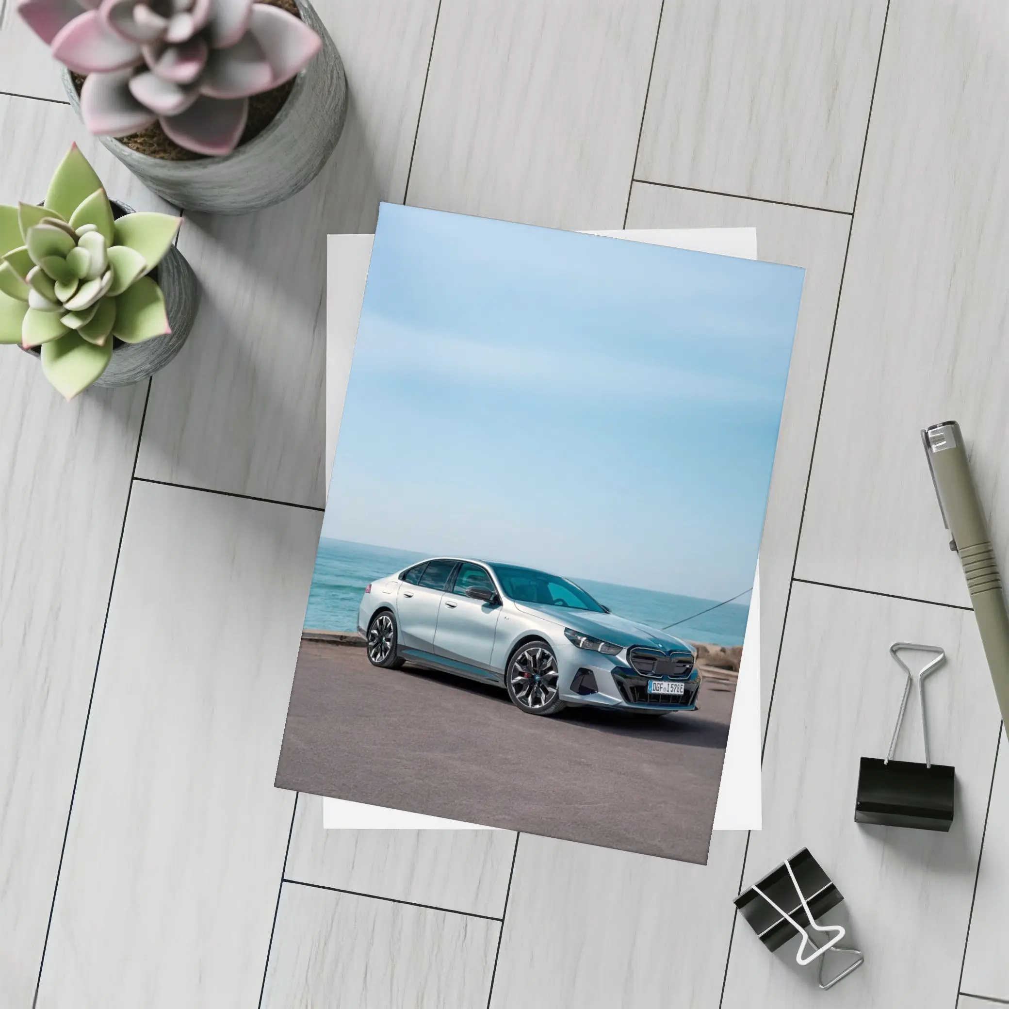 BMW i5 Sedan Parked by the Ocean – Postcards