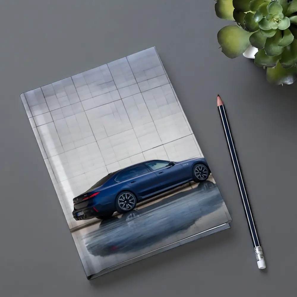 BMW i7 Blue Sedan Against Silver Wall – Notebooks