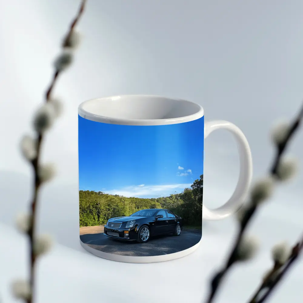 Black Cadillac CTS Parked Against Blue Sky – Mugs