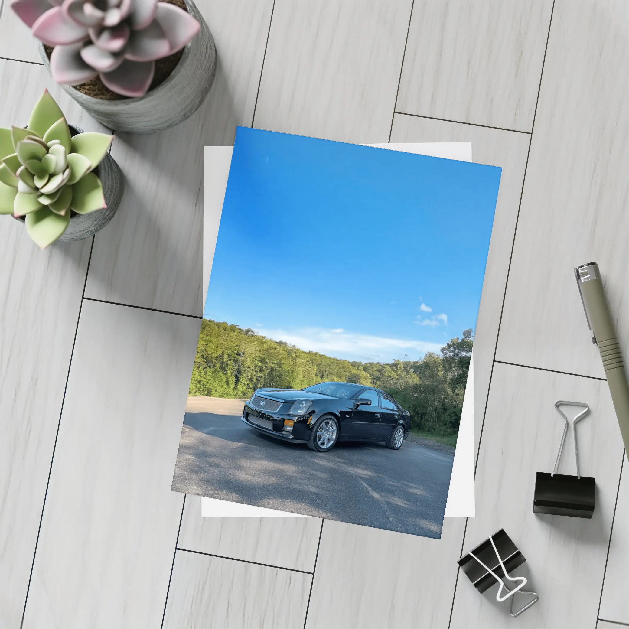 Black Cadillac CTS Parked Against Blue Sky – Postcards