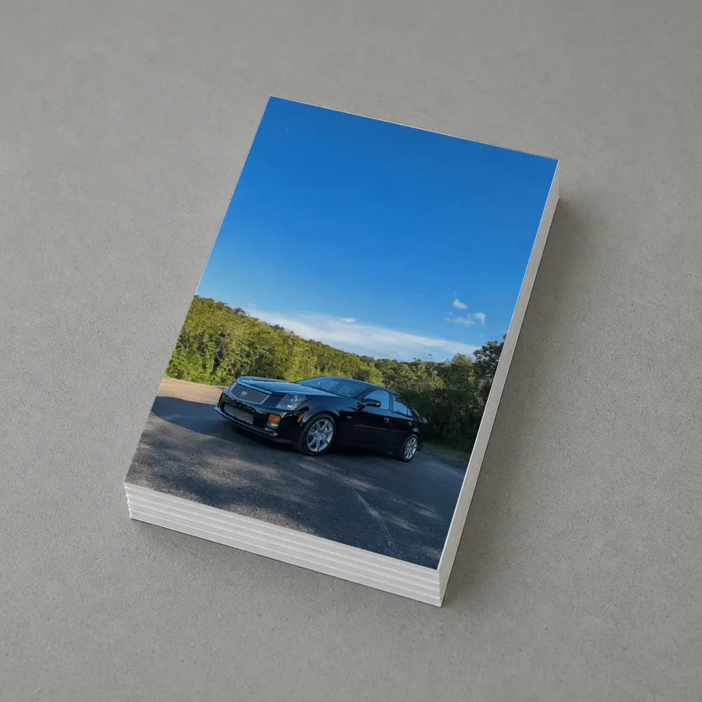 Black Cadillac CTS Parked Against Blue Sky – Postcards