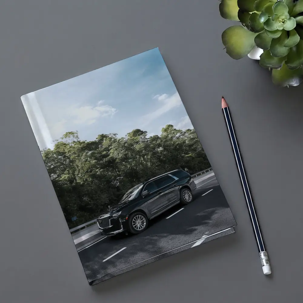 Black Cadillac Escalade SUV On Highway – Notebooks
