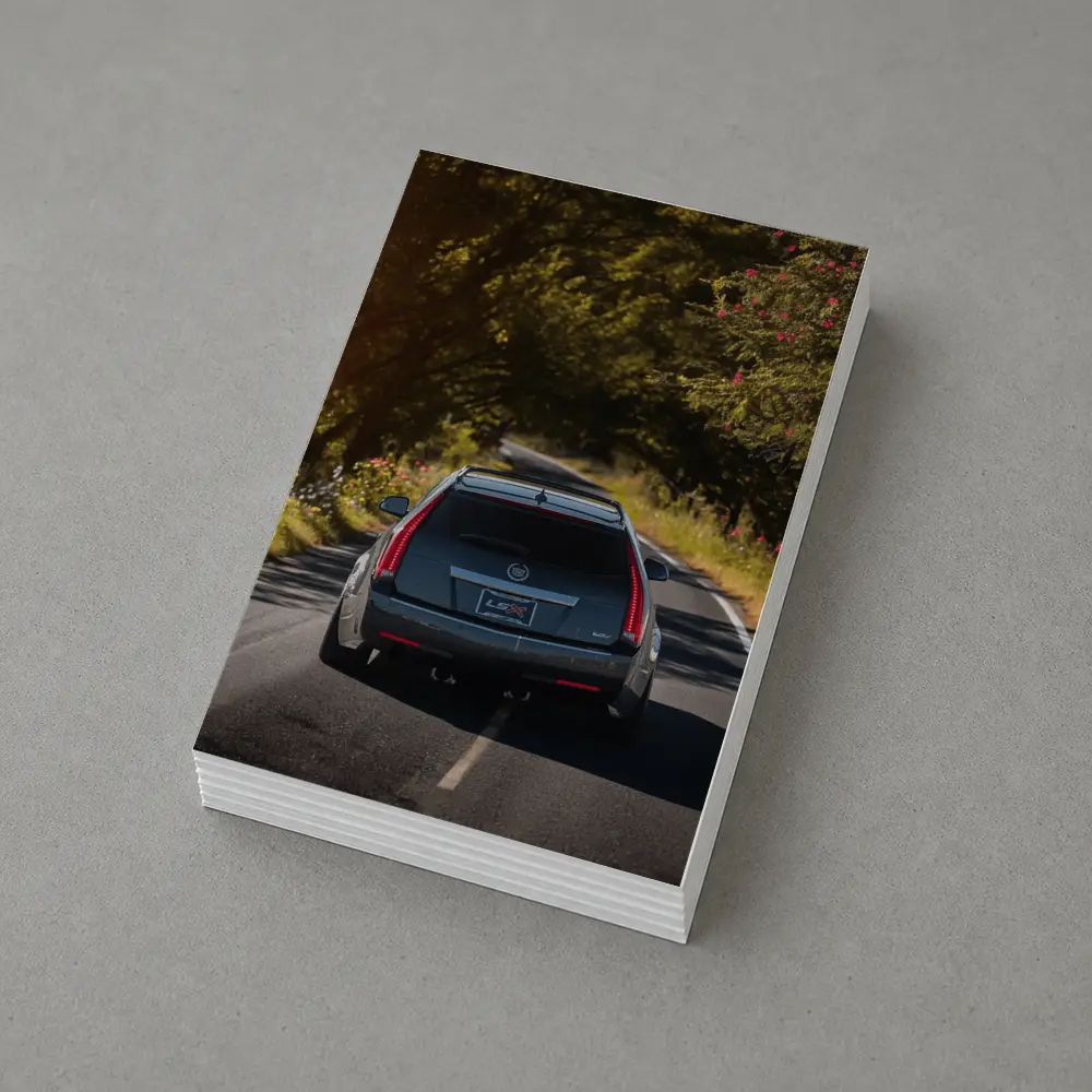 Cadillac CTS Wagon Driving Through Forest Road – Postcards