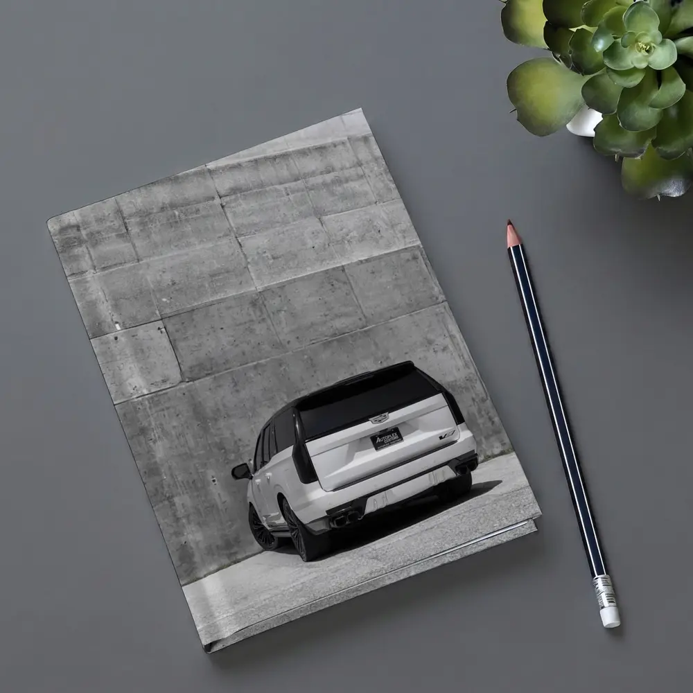 White Cadillac Escalade Against Concrete Wall – Notebooks