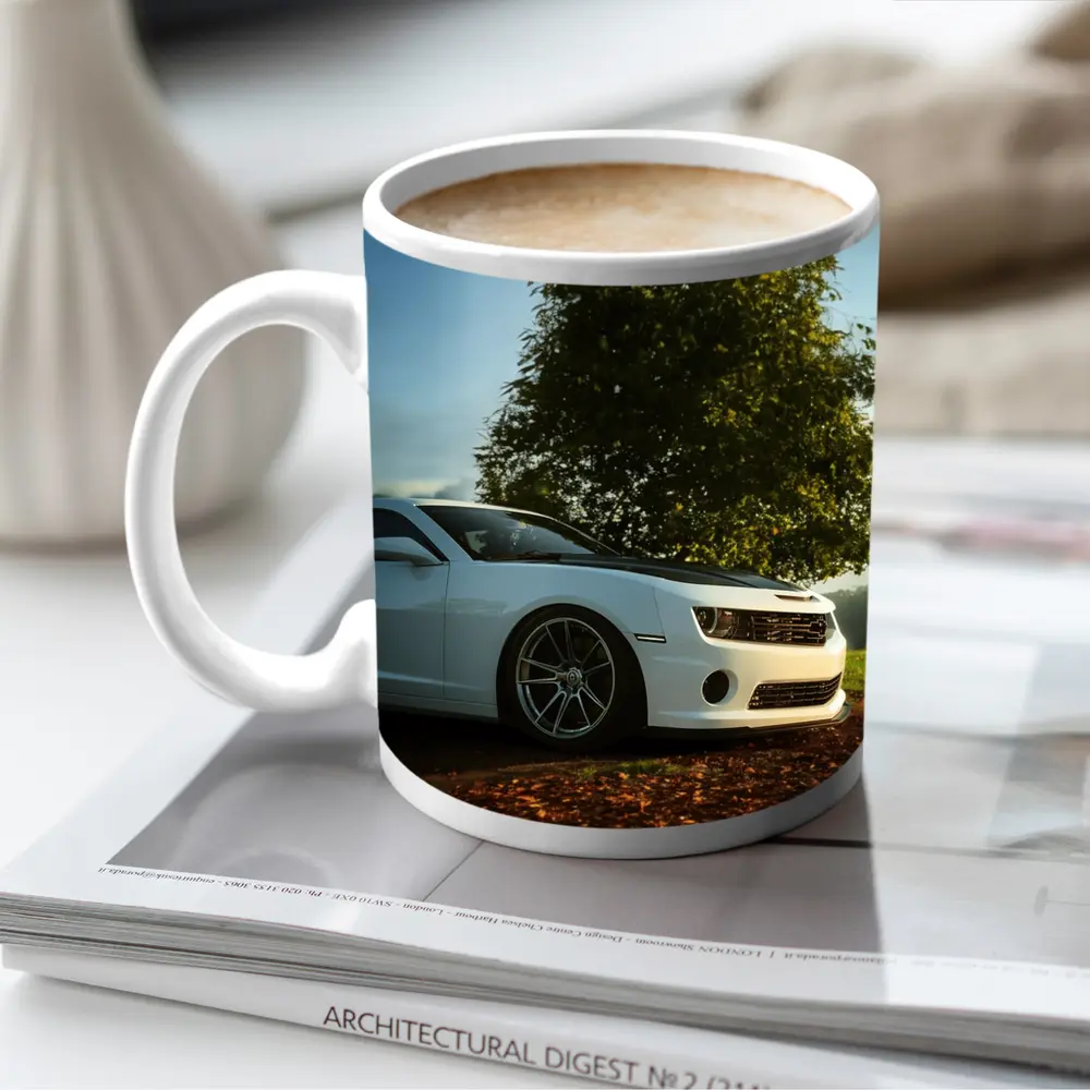 White Chevrolet Camaro Parked Near Green Tree – Mugs