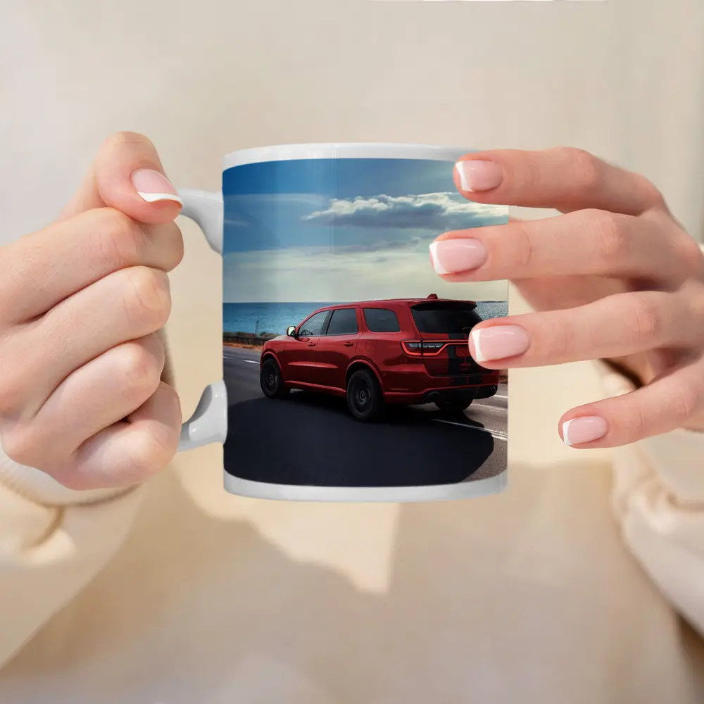 Red Dodge Durango Driving Along Coastal Road – Mugs