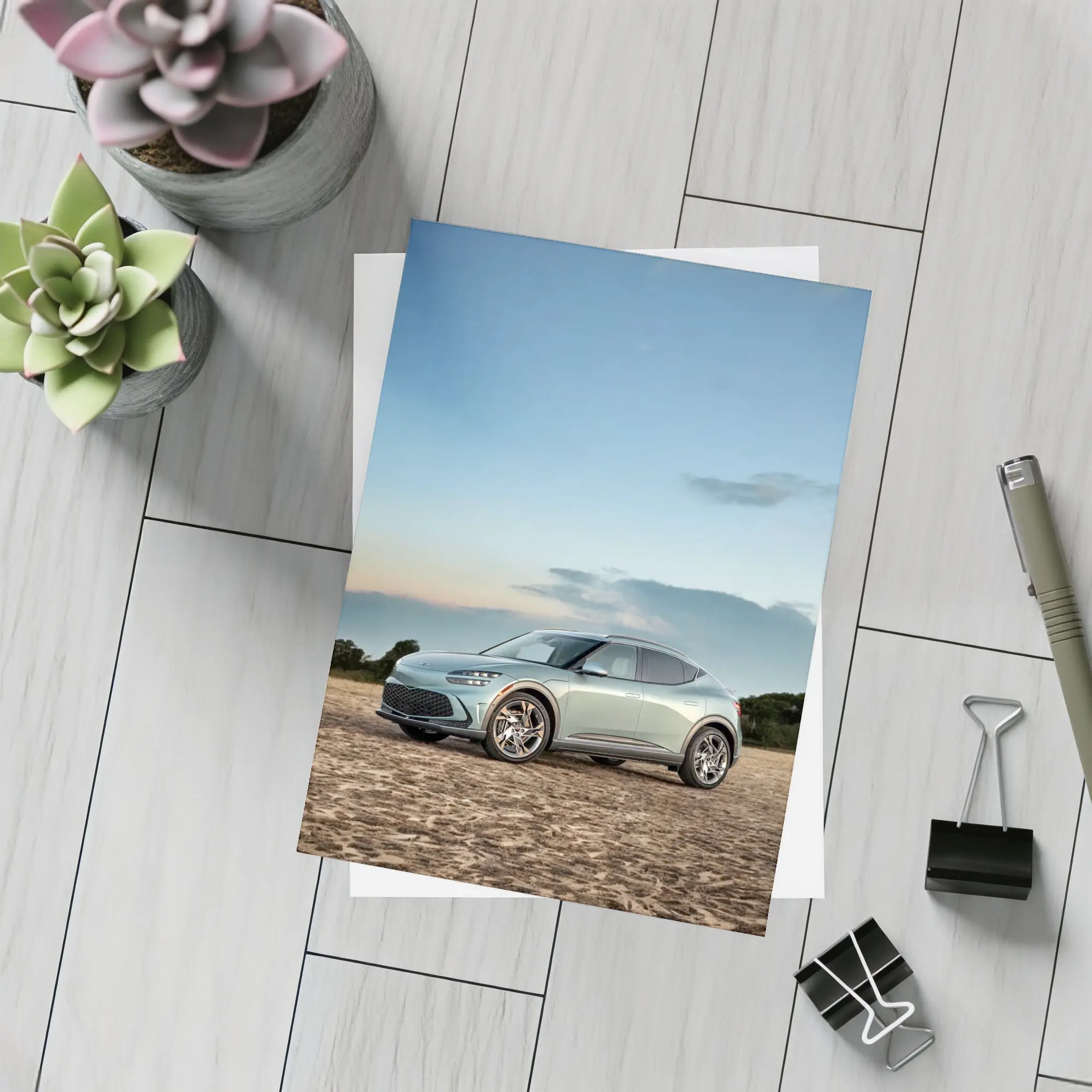 Genesis GV60 Parked on Sandy Beach – Postcards