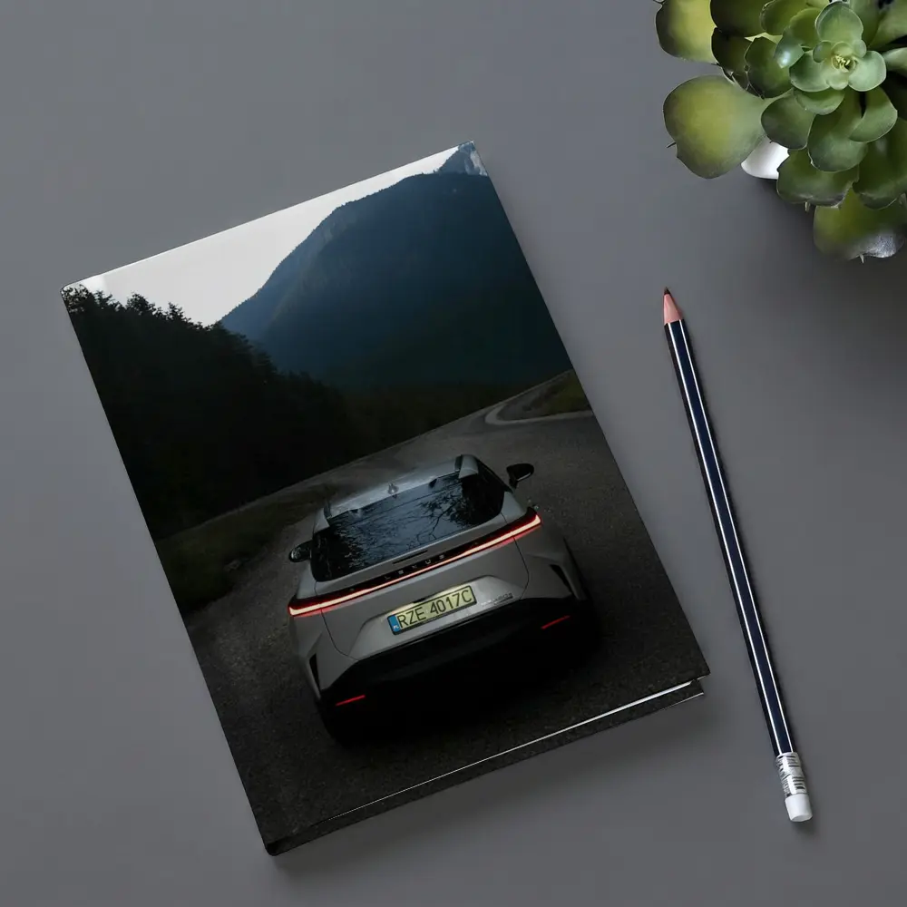 Lexus RZ On Mountain Road At Dusk – Notebooks