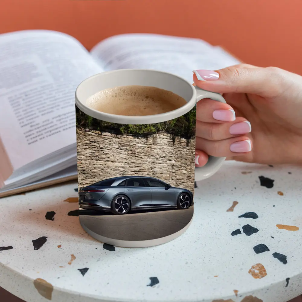 Lucid Air Sedan Parked By Stone Wall – Mugs