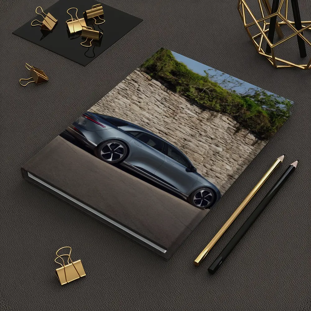 Lucid Air Sedan Parked By Stone Wall – Notebooks