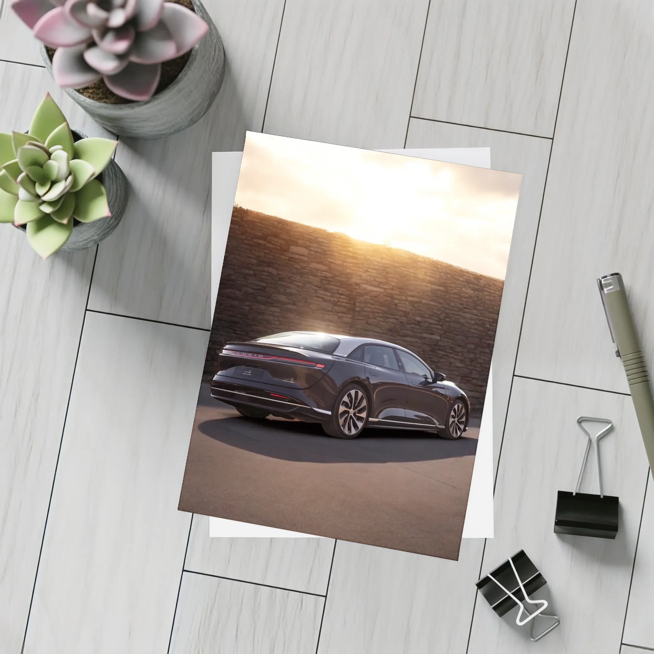 Lucid Air Sedan Parked Against Stone Wall – Postcards