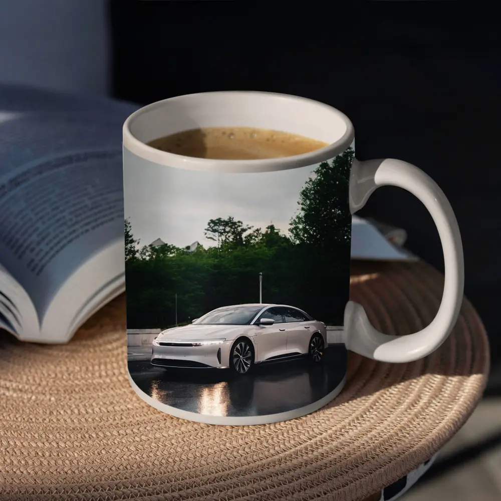 Lucid Air White Sedan Rainy City Street – Mugs