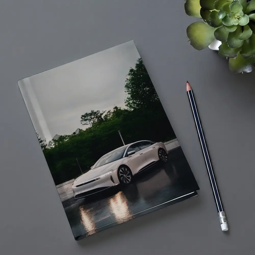 Lucid Air White Sedan Rainy City Street – Notebooks