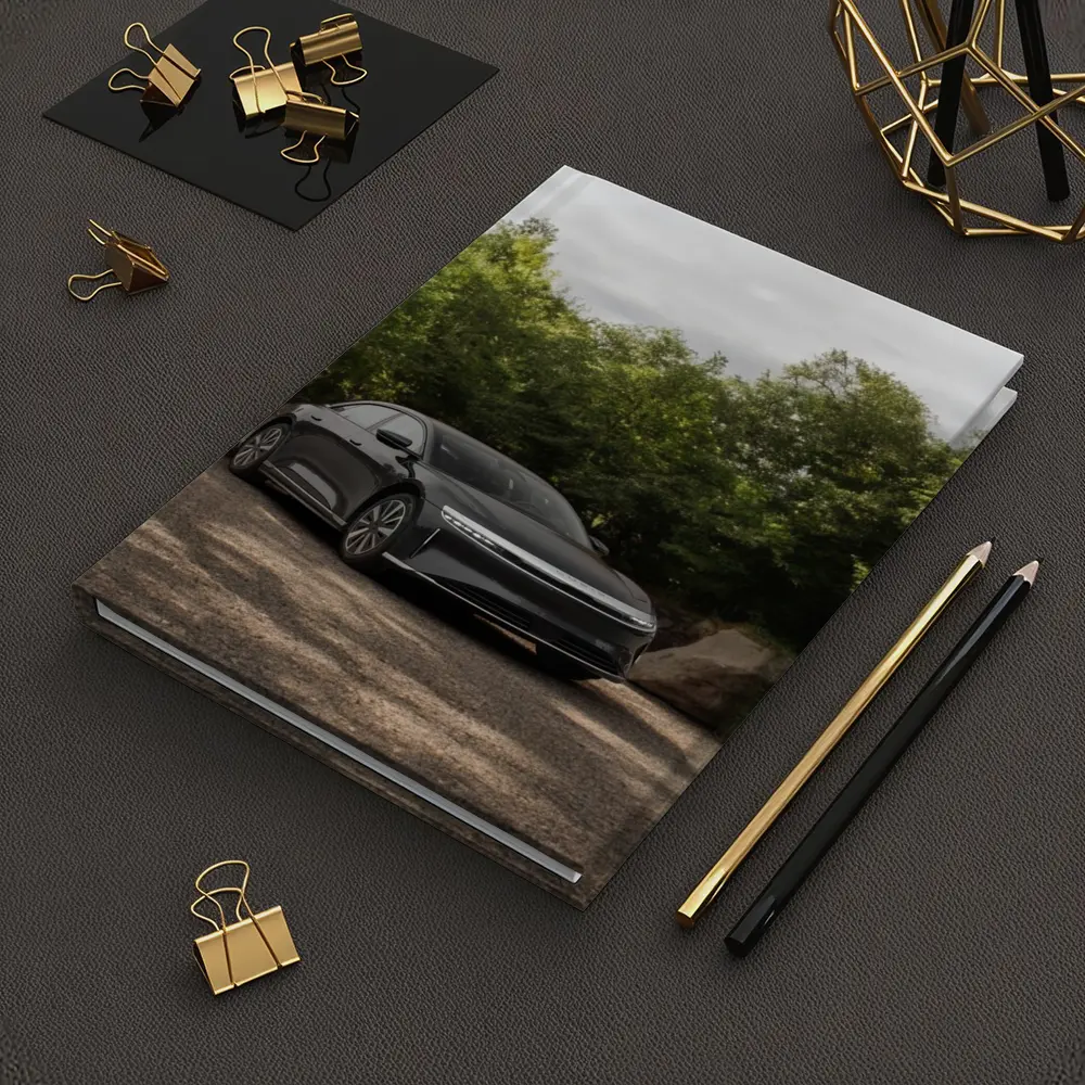 Lucid Air Dark Sedan Parked Among Trees – Notebooks